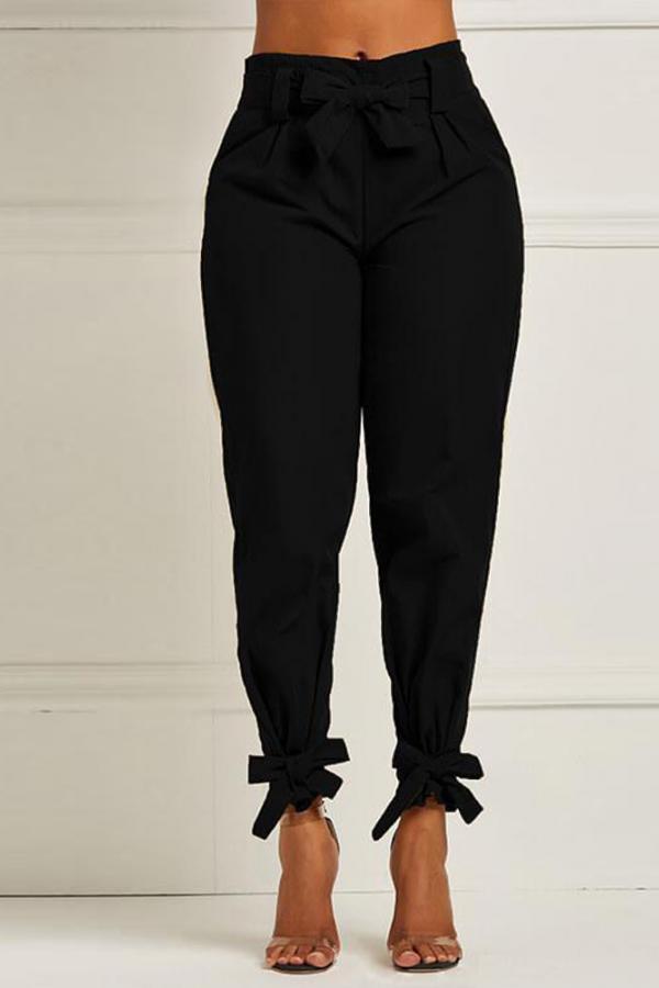 Pantaloni a matita asimmetrici con fiocco e fiocco in tinta unita neri elasticizzati