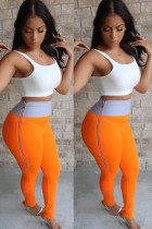 Pantalones pitillo naranja con bragueta elástica y patchwork alto