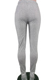 Серые эластичные узкие брюки с высоким разрезом и низом