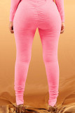 Pantaloni a matita drappeggiati con stampa alta elasticizzata in maglia rosa