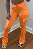 Pantaloni a stivaletto drappeggiati con tasche alte e coulisse arancioni