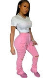 Pantaloni con taglio a stivale solido con foro drappeggiato centrale con coulisse rosa elastico