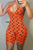 Оранжевый сексуальный узкий комбинезон с принтом в стиле пэчворк и открытой спиной с лямкой на шее