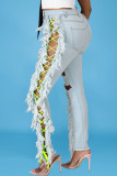 El vendaje rasgado de la borla sólida atractiva del color claro hace los pantalones vaqueros rectos viejos del dril de algodón