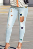 Babyblauwe, casual skinny jeans met vlinderprint en gescheurde hoge taille