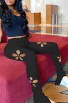 Pantalones casuales de color liso con retazos ahuecados de cintura alta con altavoz de color negro