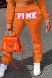 Оранжевые повседневные брюки с буквенным принтом и средней посадкой