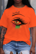 T-shirt con scollo a O patchwork stampate con occhi di strada casual arancioni
