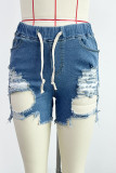 Shorts jeans cintura alta com patchwork rasgado com estampa de rua preta