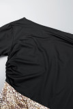 Schwarz-goldenes, elegant bedrucktes Patchwork-Kleid mit schrägem Kragen und Wickelrock in Übergröße