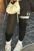 Pantalones negros con estampado casual y estampado de patchwork ajustados con cintura media y posicionamiento de lápiz