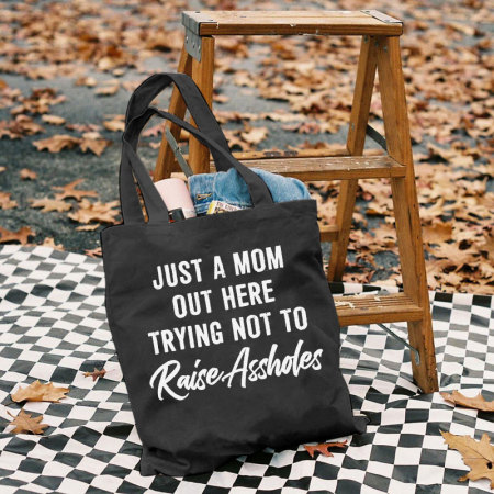 Black JUST A MOM OUT HERE TRYING NOT TO RAISE ASSHOLES PRINTED BAG
