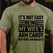 Army Green IT'S NOT EASY BEING MY WIFE'S ARM CANDY BUT HERE I AM NAILIN IT PRINT T-SHIRT