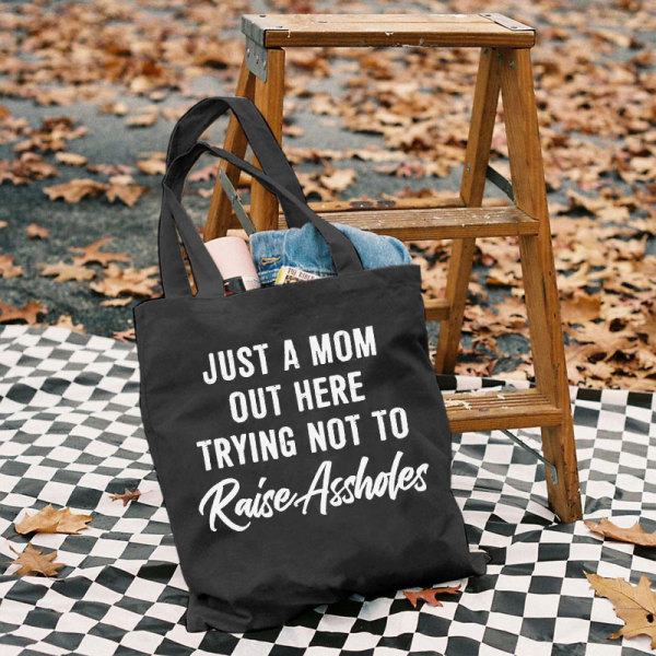 Black JUST A MOM OUT HERE TRYING NOT TO RAISE ASSHOLES PRINTED BAG