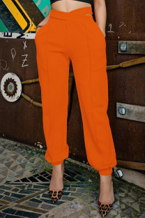 Tangerine Red Casual Solid Color Hollow Out Pocket Patchwork Regular Mid Waist Pencil Patchwork Bottoms