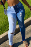 The cowboy blue Casual Color Lump Patchwork Solid Ripped Make Old Pocket Mid Waist Skinny Denim