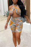 Yellow Fashion Sexy Print Hollowed Out Backless Halter Skinny Romper
