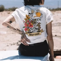 SELF CARE SKULL AND FLOWERS PRINT T-SHIRT